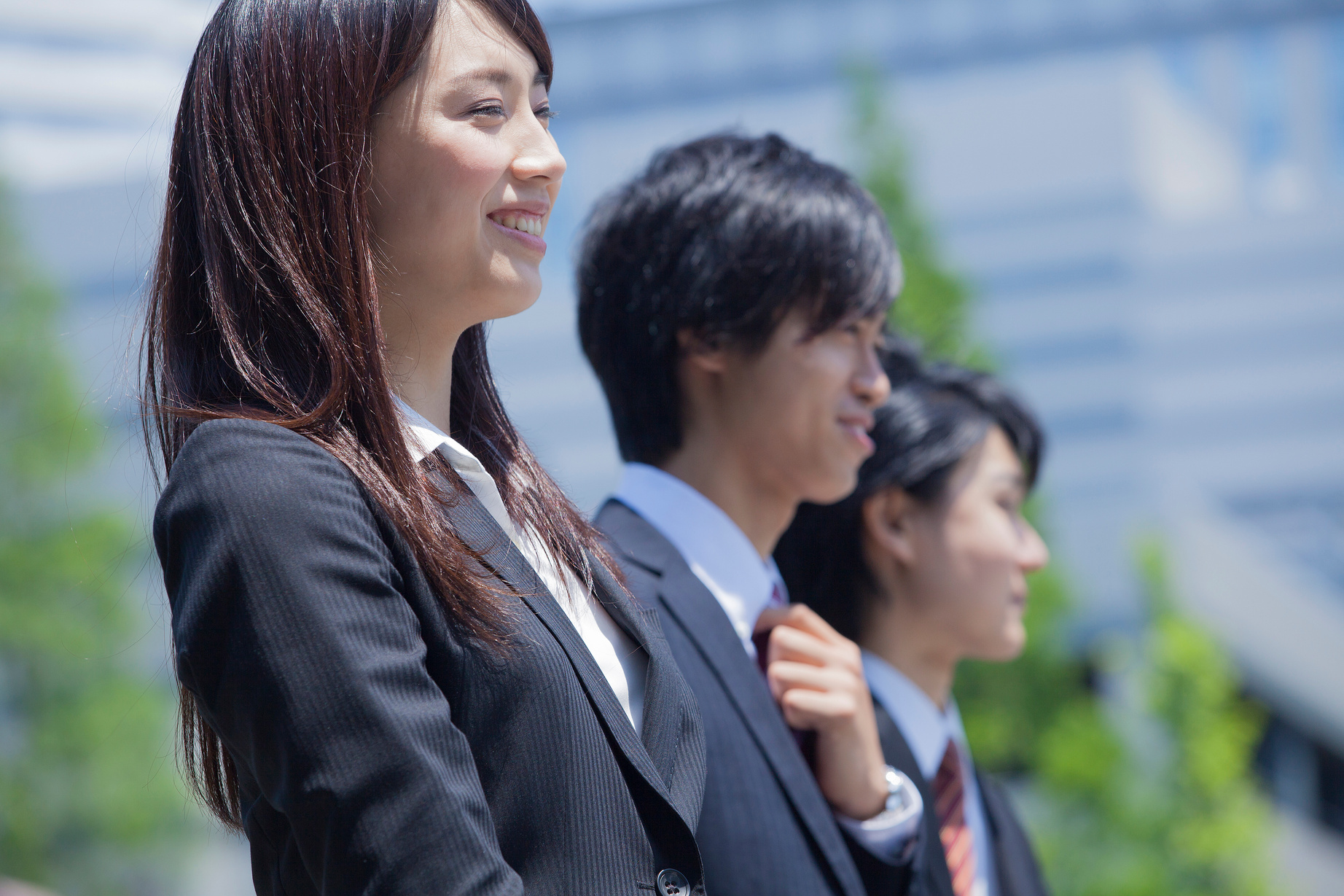 Three Japanese employees outside